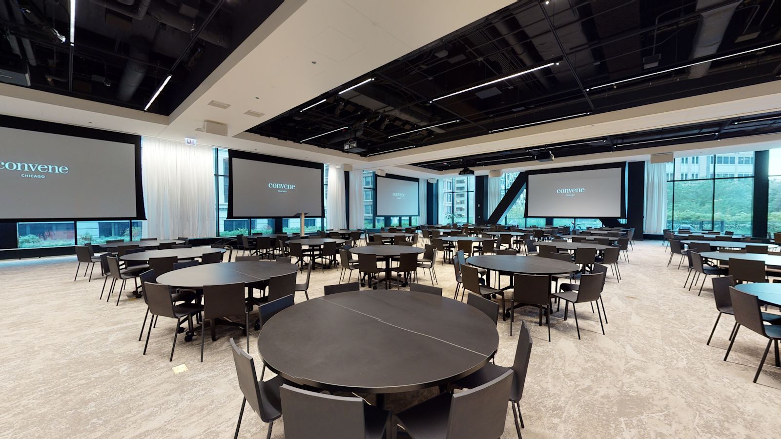 Convene's main hall set in rounds with presentation screens