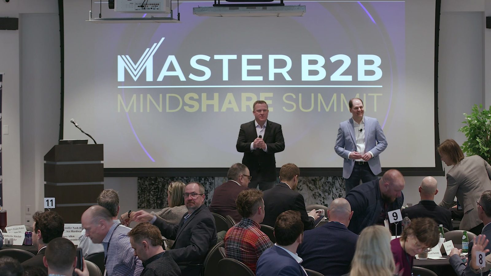 The hosts opening the Summit under the Mindshare screen
